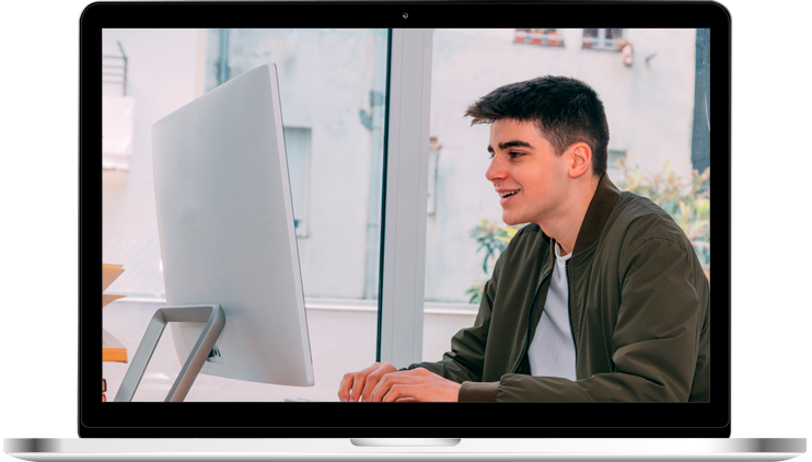 Joven sonriente mirando la computadora roja